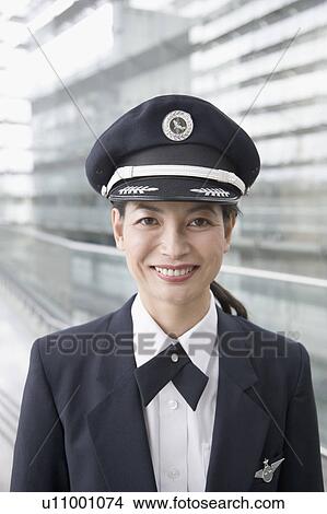 Picture - Portrait of a female pilot smiling. Fotosearch