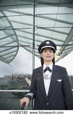 Portrait of a female pilot smiling View Large Photo Image Stock Image - Portrait of a female pilot smiling. Fotosearch