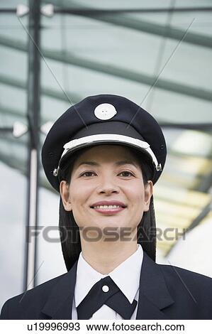 Stock Image - Portrait of a female pilot smiling. Fotosearch