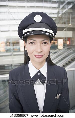 Portrait of a female pilot smiling View Large Photo Image Stock Photo - Portrait of a female pilot smiling. Fotosearch