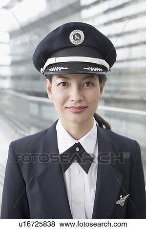 Stock Photo - Portrait of a female pilot smiling. Fotosearch