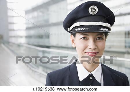 Stock Photo - Portrait of a female pilot smiling. Fotosearch