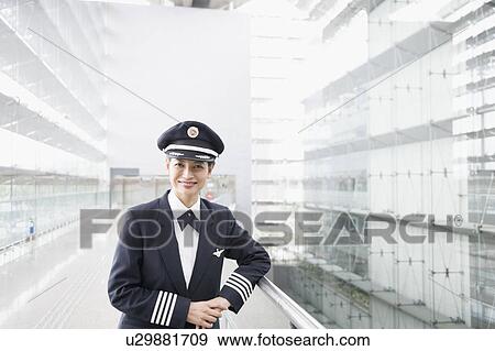 Stock Photo - Portrait of a female pilot smiling. Fotosearch