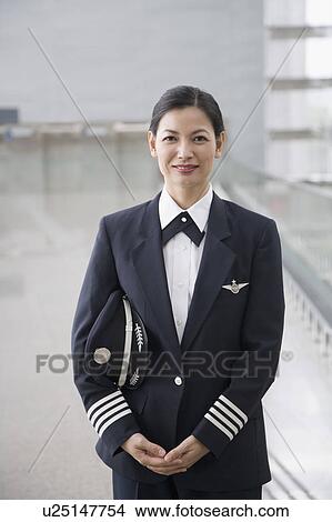 Portrait of a female pilot standing View Large Photo Image Picture - Portrait of a female pilot standing. Fotosearch