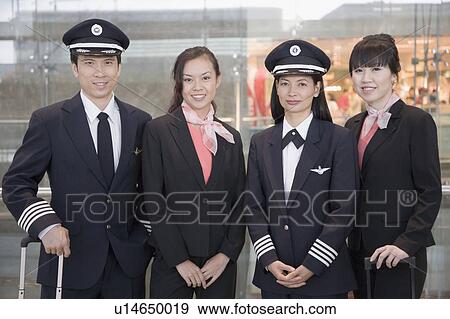 Portrait of a male and a female pilot standing with two female cabin crews View Large Photo Image Stock Photo - Portrait of a male and a female pilot standing with two female cabin crews. Fotosearch