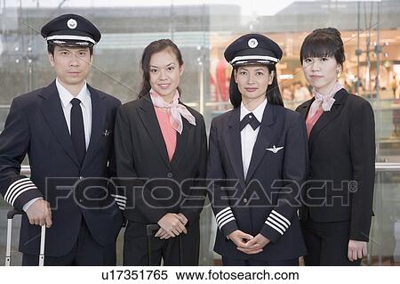 Portrait of a male and a female pilot standing with two female cabin crews View Large Photo Image Stock Photography - Portrait of a male and a female pilot standing with two female cabin crews. Fotosearch