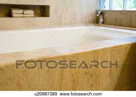 Stock Photo - Detail of bathtub and towels.. Fotosearch