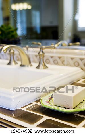 Stock Image - Detail of colorful soap dish with soap. Fotosearch