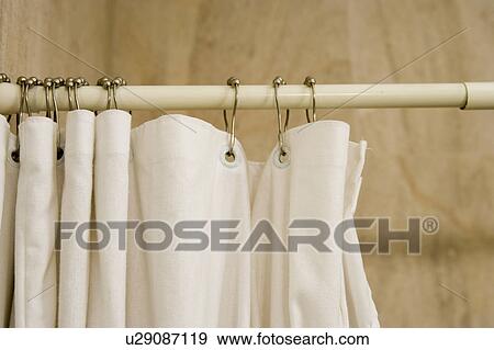 Stock Photo - Detail of white shower curtain rings on rod.. Fotosearch