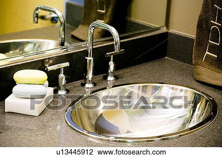 Stock Image - Metal bathroom sink and faucet. Fotosearch