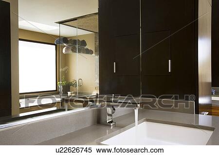 Modern bathroom vanity with reflection of jacuzzi tub View Large Photo Image Stock Photography - Modern bathroom vanity with reflection of jacuzzi tub. Fotosearch