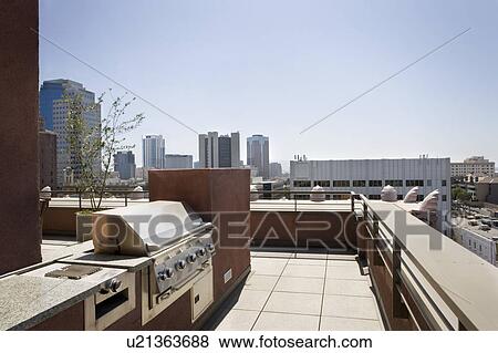 BBQ area on patio with city view in background View Large Photo Image Stock Photo - BBQ area on patio with city view in background. Fotosearch