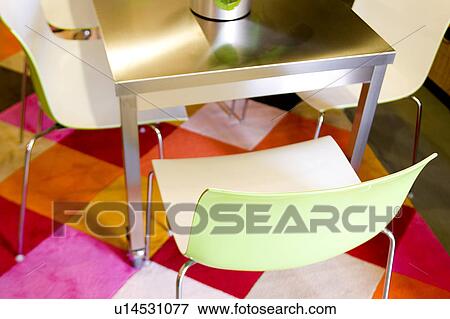 Stock Photo - Modern Green Plastic Chair on Bright Rug. Fotosearch