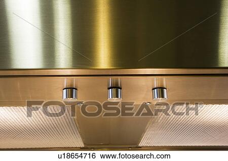 Stock Photograph - Overhead chrome stovetop vent. Fotosearch