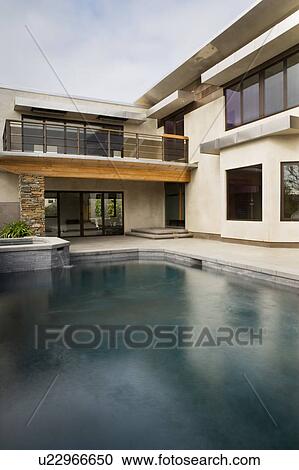 Rear Exterior of Modern Home and Swimming Pool View Large Photo Image Stock Image - Rear Exterior of Modern Home and Swimming Pool. Fotosearch