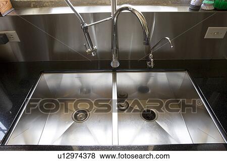 Stock Photo - Stainless steel kitchen sink.. Fotosearch