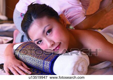 Stock Photo - Masseuse using elbow to for pressure point massage, close-up. Fotosearch