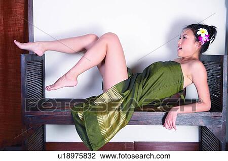 Young womain raising leg in spa room, full length, View Large Photo Image Stock Image - Young womain raising leg in spa room, full length,. Fotosearch