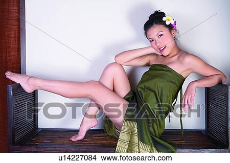 Young womain sitting in spa room, full length, View Large Photo Image Picture - Young womain sitting in spa room, full length,. Fotosearch