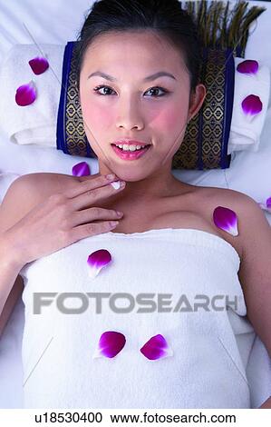 Young woman lying down, top view View Large Photo Image Stock Image - Young woman lying down, top view. Fotosearch