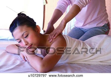 Young woman wearing towel, getting a massage with eyes closed, side view View Large Photo Image Stock Photo - Young woman wearing towel, getting a massage with eyes closed, side view. Fotosearch