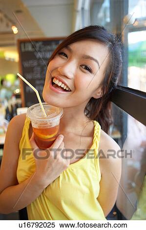 Stock Photography - Young Lady Holding Cold Drink. Fotosearch