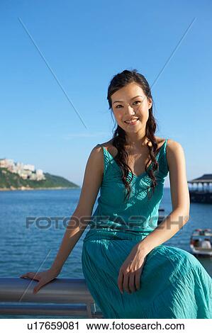 Young Lady Sitting on Railing of Fence, Smiling View Large Photo Image Stock Image - Young Lady Sitting on Railing of Fence, Smiling. Fotosearch
