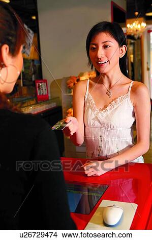 Young woman using credit card to pay money View Large Photo Image Picture - Young woman using credit card to pay money. Fotosearch