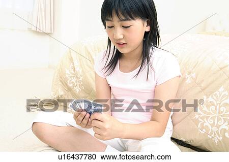 Stock Image - Girl playing cards. Fotosearch
