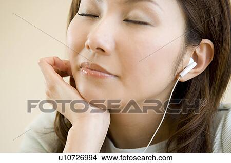 Picture - Woman listening music. Fotosearch