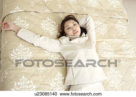 Woman liying in a bed View Large Photo Image Stock Image - Woman liying in a bed. Fotosearch