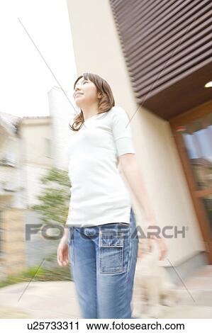 Stock Image - Woman looking up to the sky. Fotosearch
