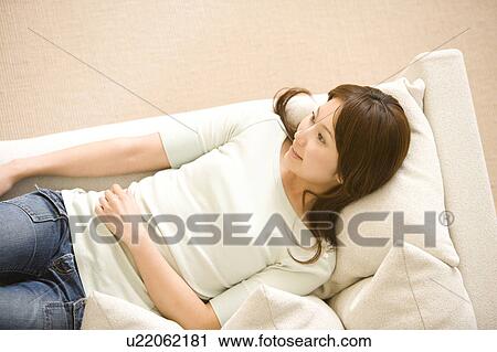 Woman lying on her back View Large Photo Image Stock Image - Woman lying on her back. Fotosearch