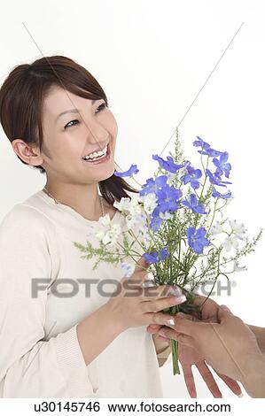 Woman receiving a flower View Large Photo Image Stock Photograph - Woman receiving a flower. Fotosearch