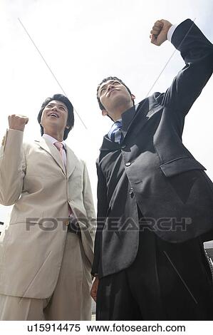 Stock Photography - Businessmen doing gats pose. Fotosearch