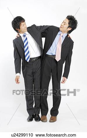 Stock Image - Businessmen grappling each shoulder. Fotosearch