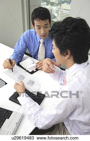 Businessmen having a meeting View Large Photo Image Stock Image - Businessmen having a meeting. Fotosearch