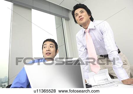 Businessmen having a meeting View Large Photo Image Stock Photo - Businessmen having a meeting. Fotosearch