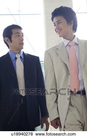Businessmen walking together View Large Photo Image Stock Photo - Businessmen walking together. Fotosearch