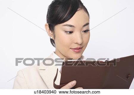 Business lady checking a notebook View Large Photo Image Stock Image - Business lady checking a notebook. Fotosearch
