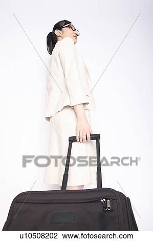 Business lady pulling a carry bag View Large Photo Image Stock Image - Business lady pulling a carry bag. Fotosearch