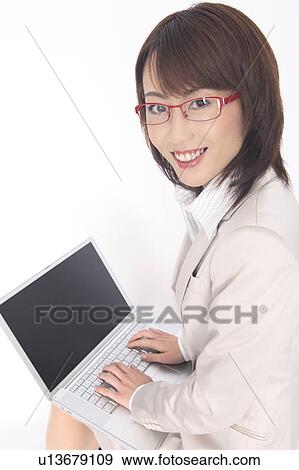 Business lady who looks back hitting the laptop computer View Large Photo Image Stock Photo - Business lady who looks back hitting the laptop computer. Fotosearch