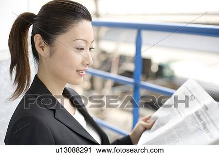 Business lady who reads a newspaper View Large Photo Image Stock Image - Business lady who reads a newspaper. Fotosearch