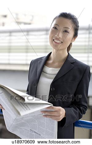 Business lady who reads a newspaper View Large Photo Image Stock Photo - Business lady who reads a newspaper. Fotosearch