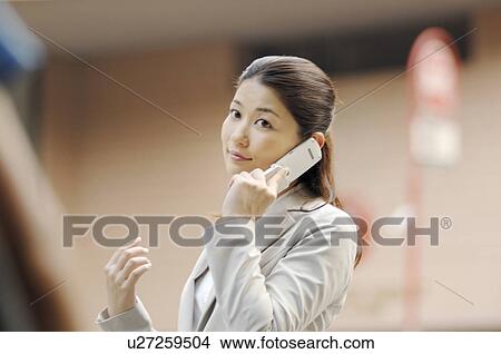 Business lady who speaks with the cell phone View Large Photo Image Picture - Business lady who speaks with the cell phone. Fotosearch