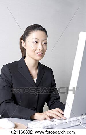 Woman operating a PC View Large Photo Image Stock Image - Woman operating a PC. Fotosearch