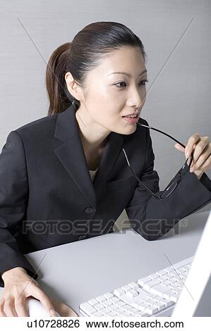 Woman operating a PC View Large Photo Image Stock Photograph - Woman operating a PC. Fotosearch