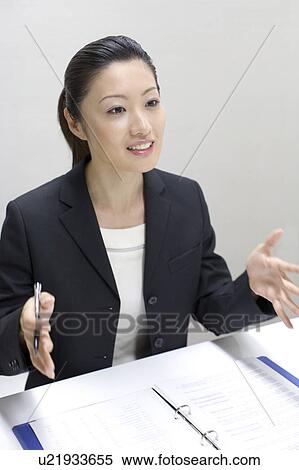 Stock Photography - Woman who talks a business discussion. Fotosearch