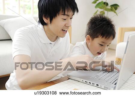 Boy playing with his father View Large Photo Image Stock Photo - Boy playing with his father. Fotosearch