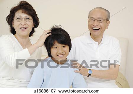 Stock Photo - Elderly couple and grandchild. Fotosearch